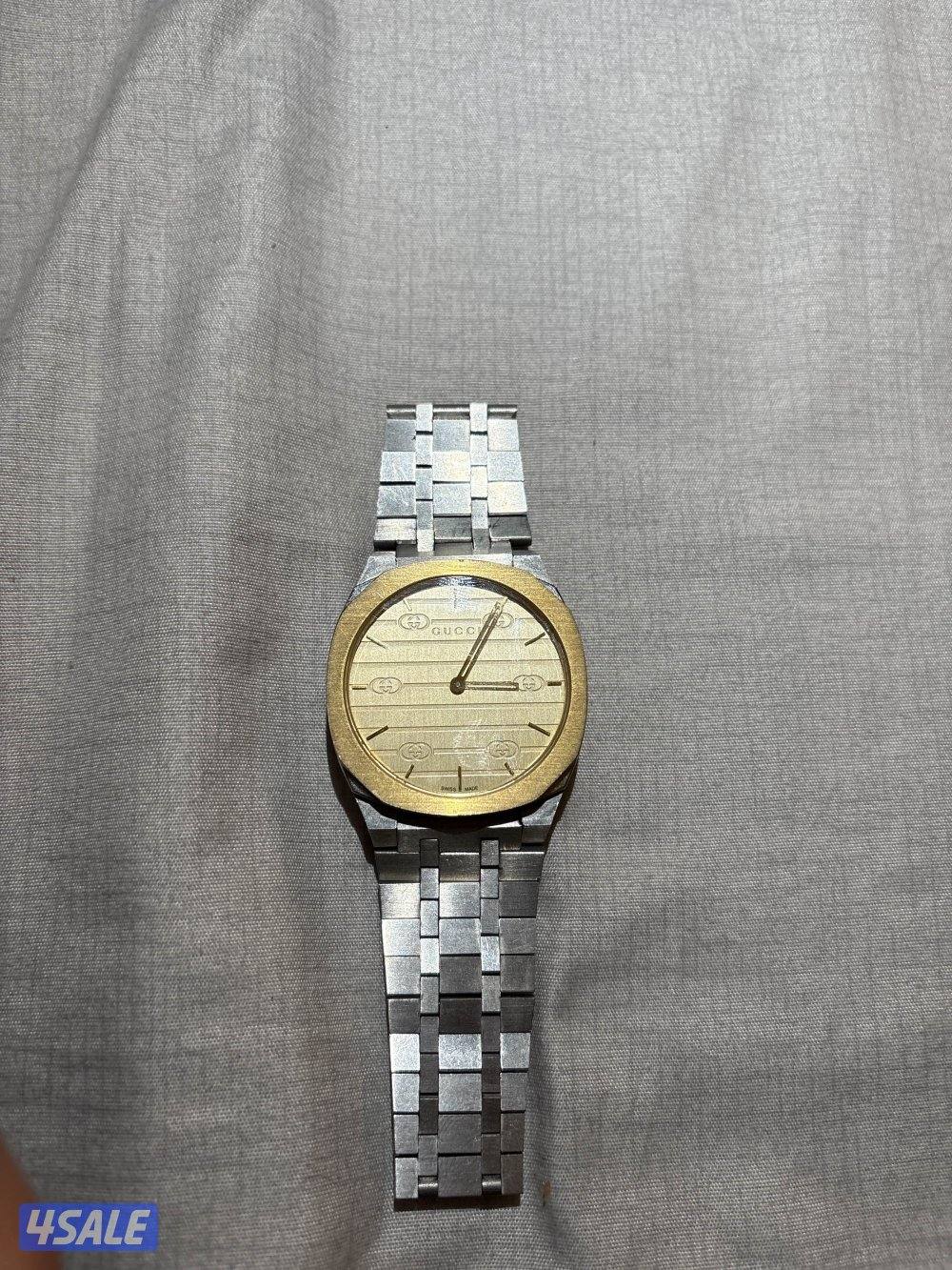 ساعه Gucci ذهبيه0