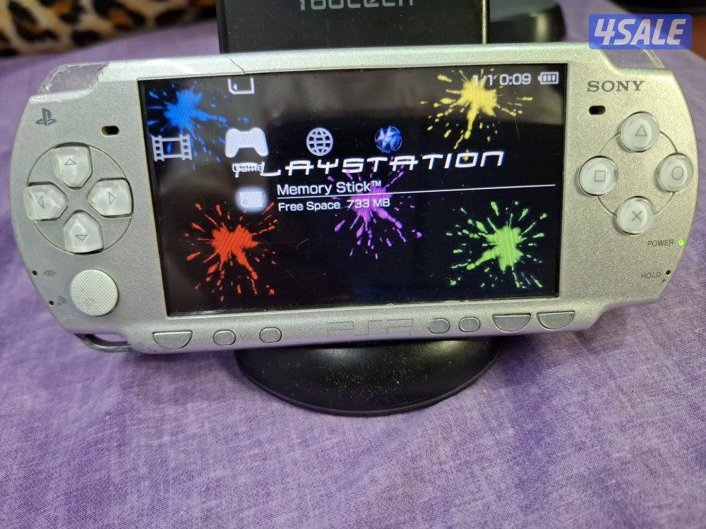 PSP SLIM P2000 MODEL..GREY COLOR 8GB SD CARD WITH 45 GAMES0