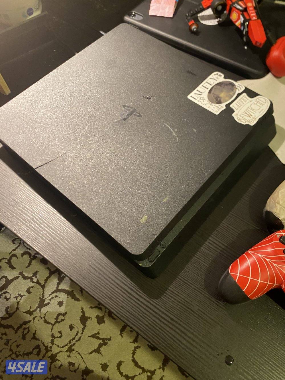 PS4 slim good condition with games and controller0