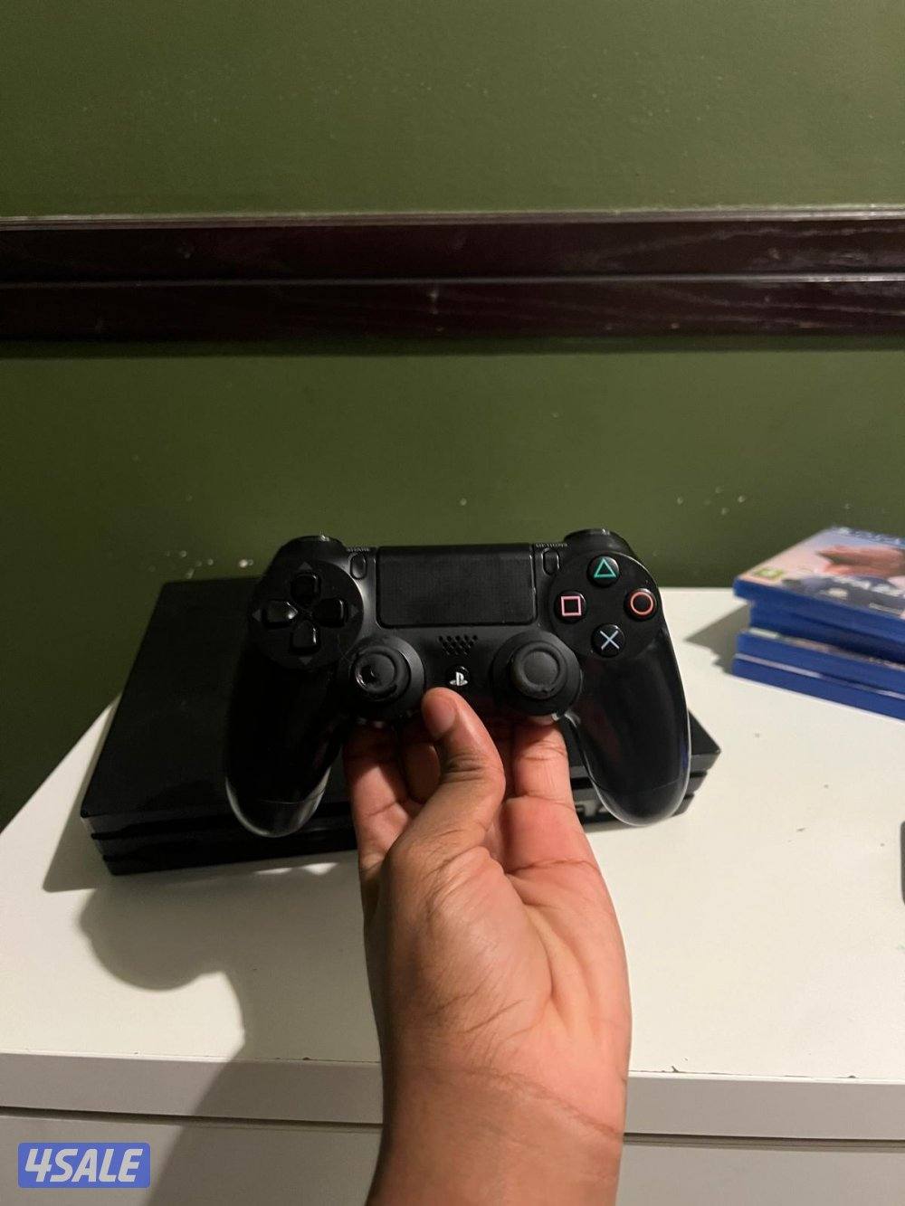 playstaion 4 pro with a controller in good condition with games0