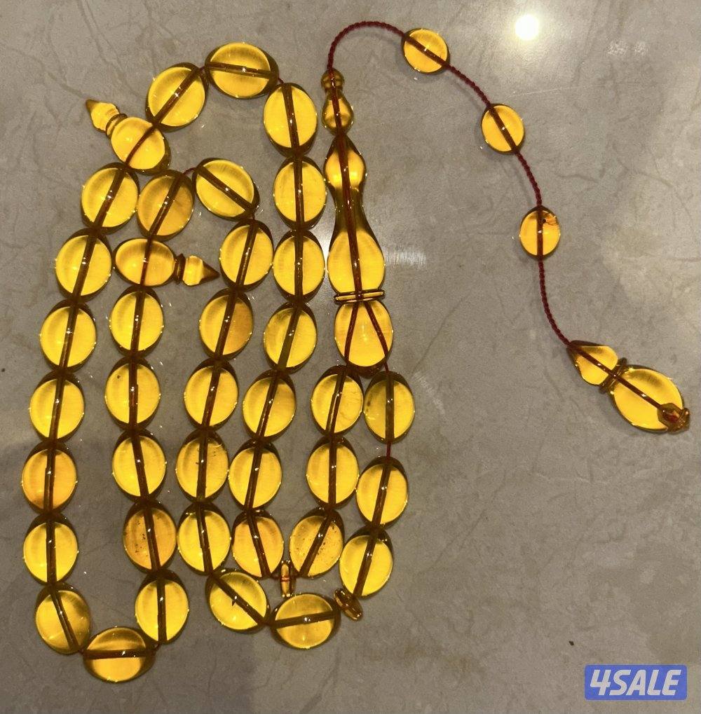 مسباح كهرب بولندي شفاف ب قصة الزيتون. لون المسباح غامج و وزنه ٥١ غرام0