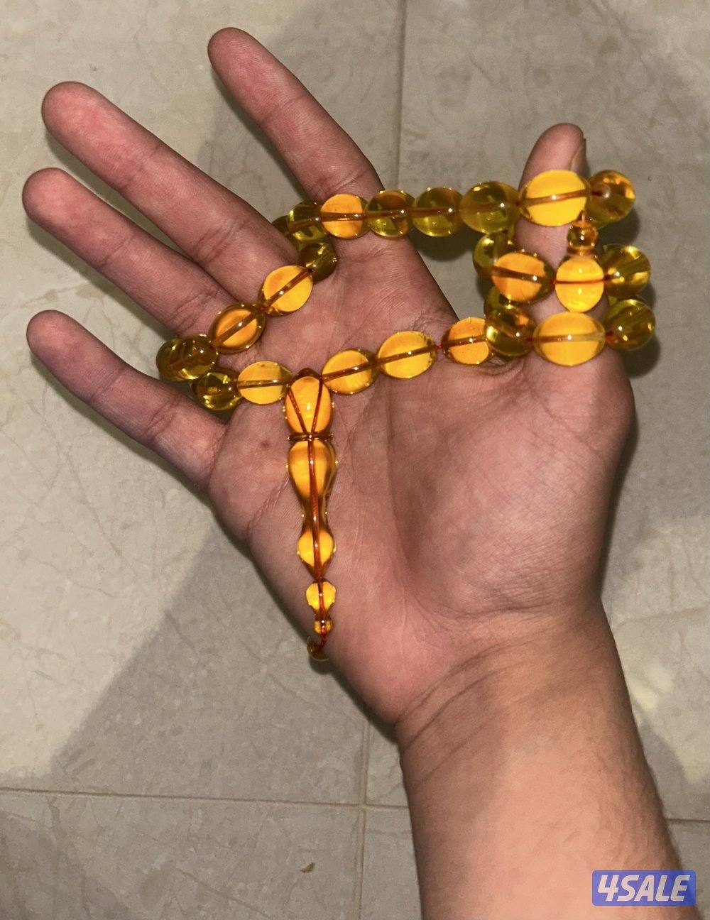 مسباح كهرب بولندي شفاف ب قصة الزيتون. لون المسباح غامج و وزنه ٥١ غرام2